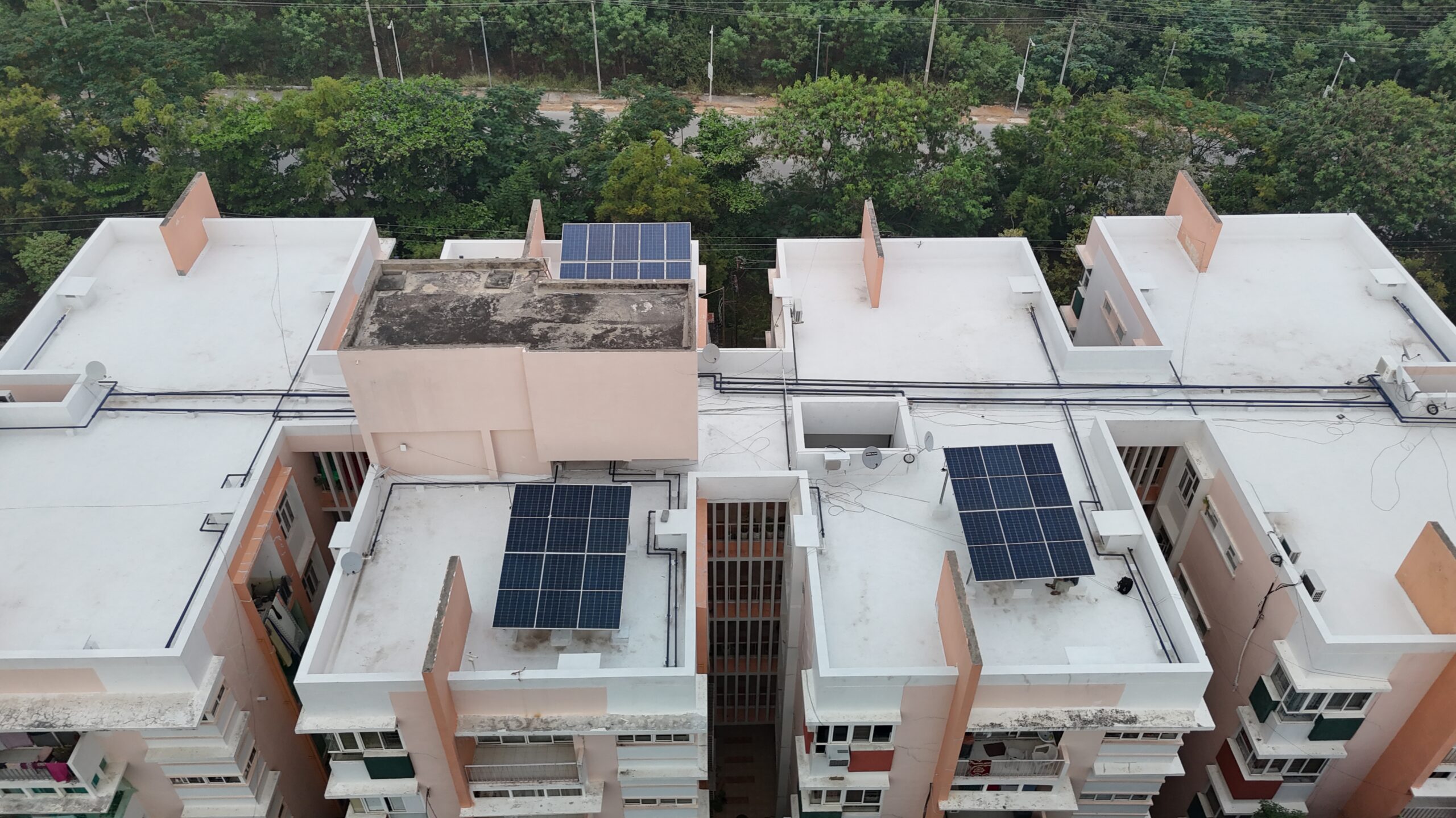 Workers fixing solar modules provided by solar panel companies in Warangal.